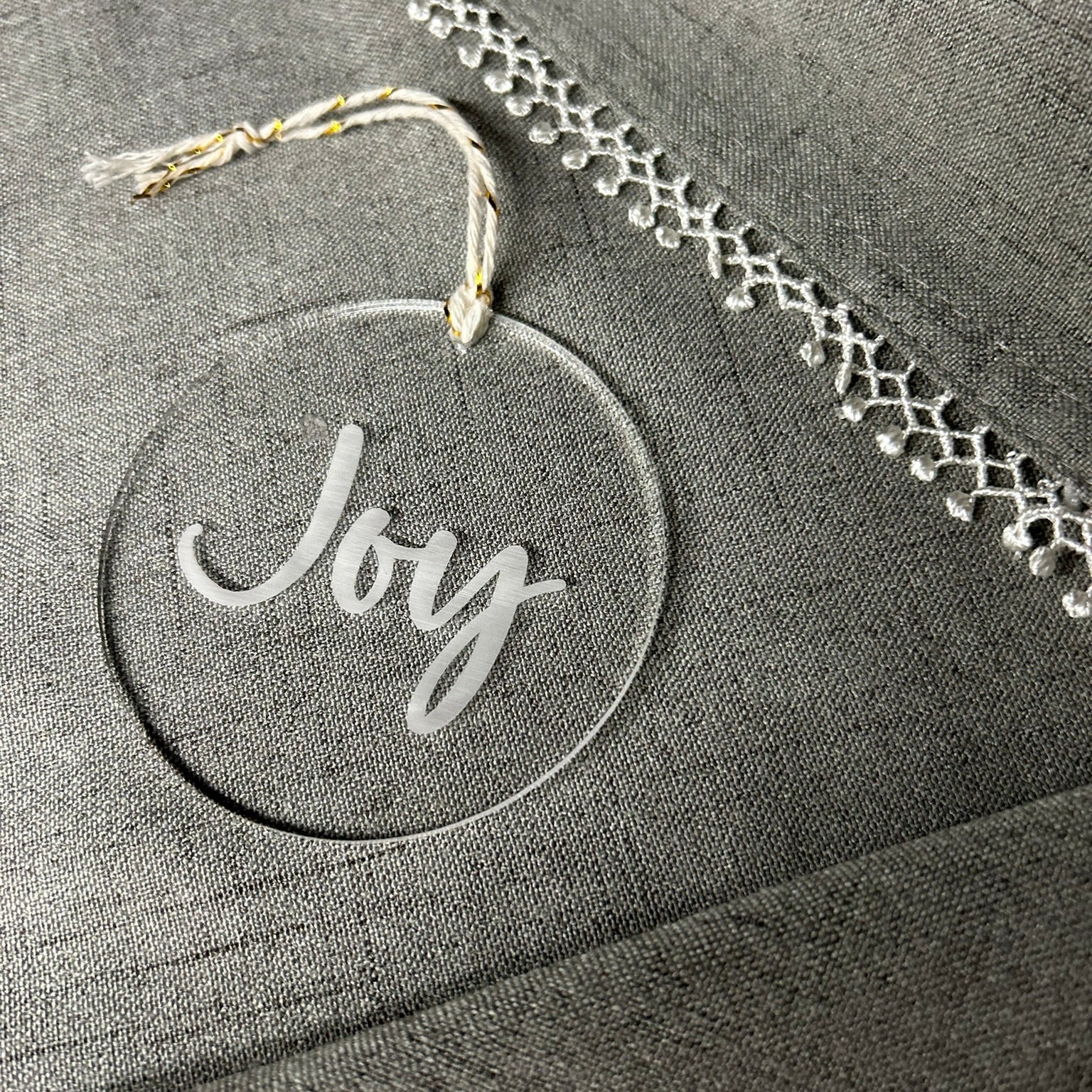 Decorative ornament with 'Joy' text on a textured surface